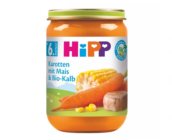 Läbipaistev rohelise kaanega purk sisaldab toiduaine märgistusega "Hipp", mis keskendub porgandile, maisile ja lihakomponendile ning on tähistatud biosümboliga.