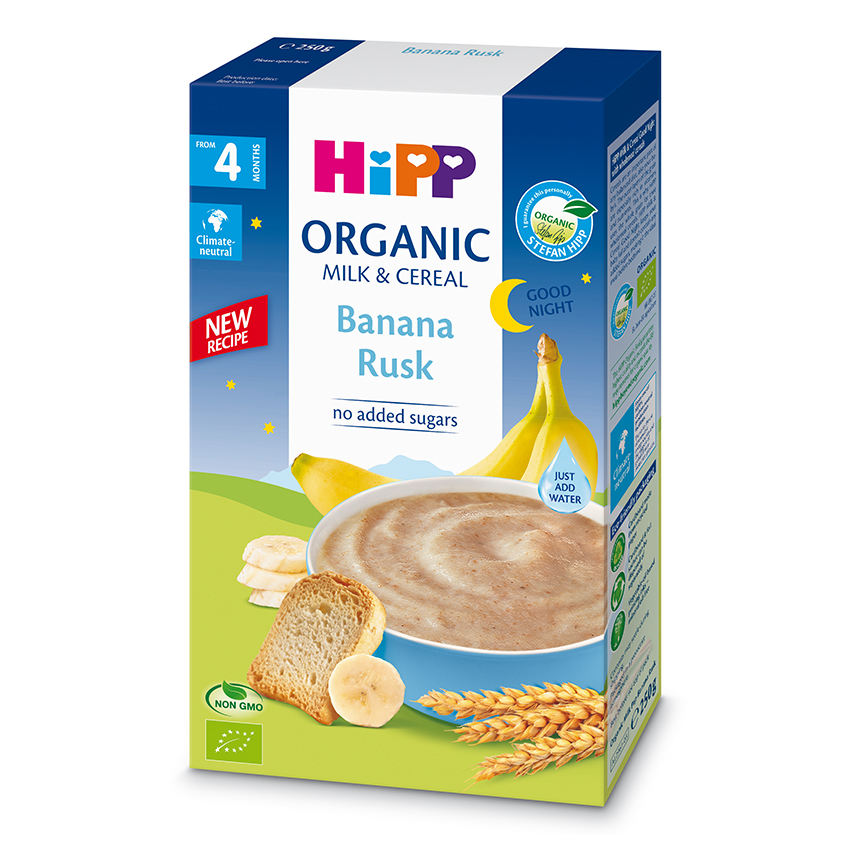 Ristkülikukujulisel karbil on toode "Hipp Organic Milk & Cereal Banana Rusk", mille esiküljel on kujutatud kaussi banaanikõrvitsat, banaani ja leivaviilu.